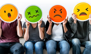 Unhappy people holding emoticons