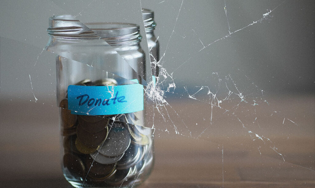 coins in a jar with blue tape on which is written "donate"